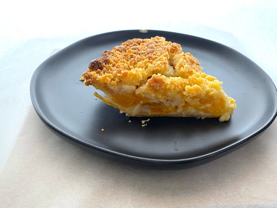 Make dessert a breeze with our ready-to-bake Peach Apple Crumb Pie from Flaky Apple Pie Company. Delight your friends and family with this effortless, delicious treat that you baked!