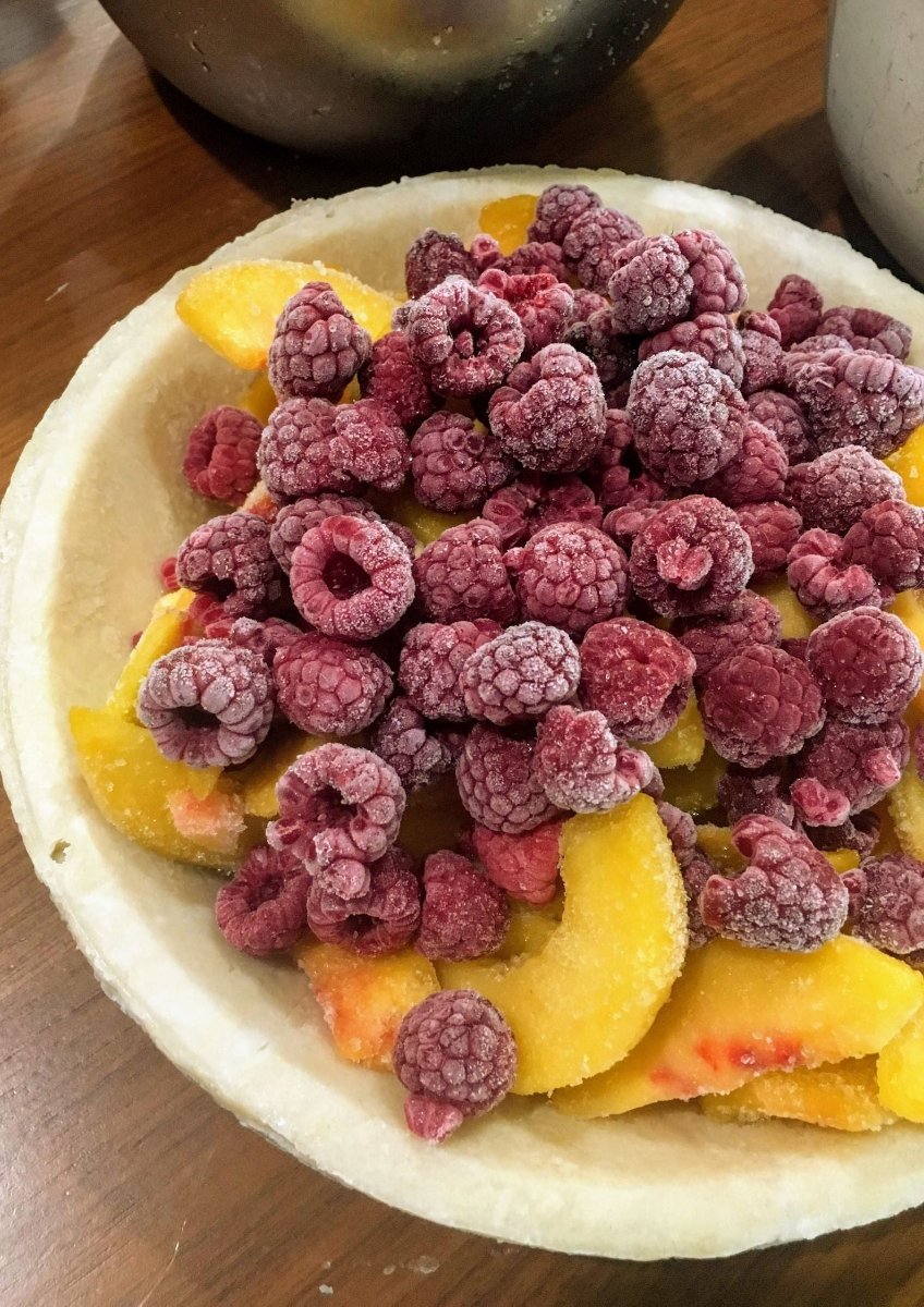 Make dessert a breeze with our ready-to-bake Peach Melba Pie from Flaky Apple Pie Company. Delight your friends and family with this effortless, delicious treat that you baked!